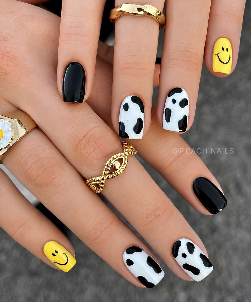 Back nails with cow print and yellow happy faces