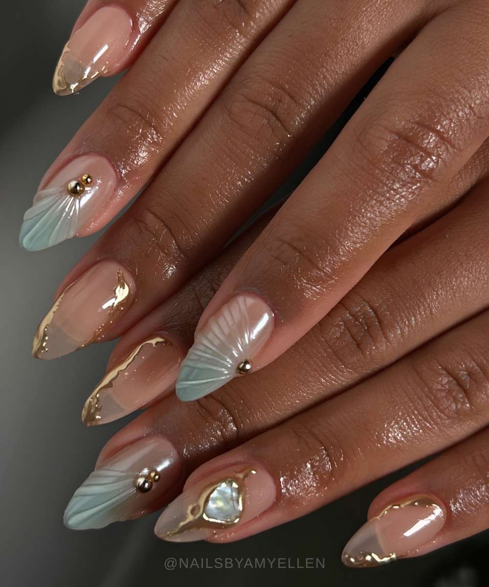 Blue ombre nails with gold accents and shell art