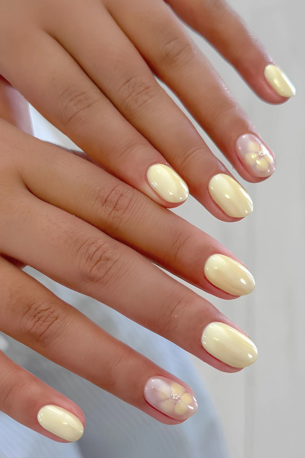 Butter yellow chrome nails with blooming gel flowers