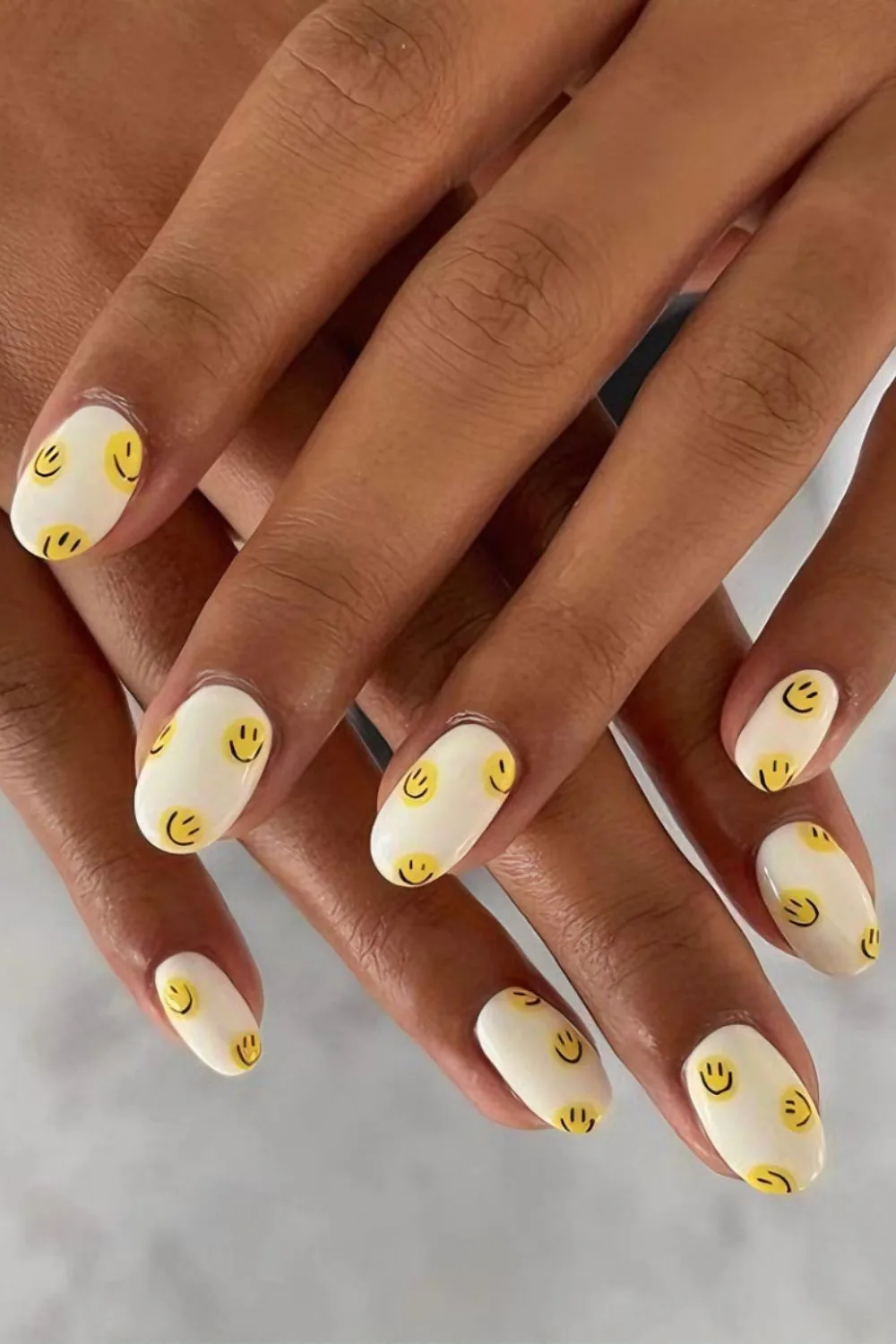 Creamy white nails with smileys