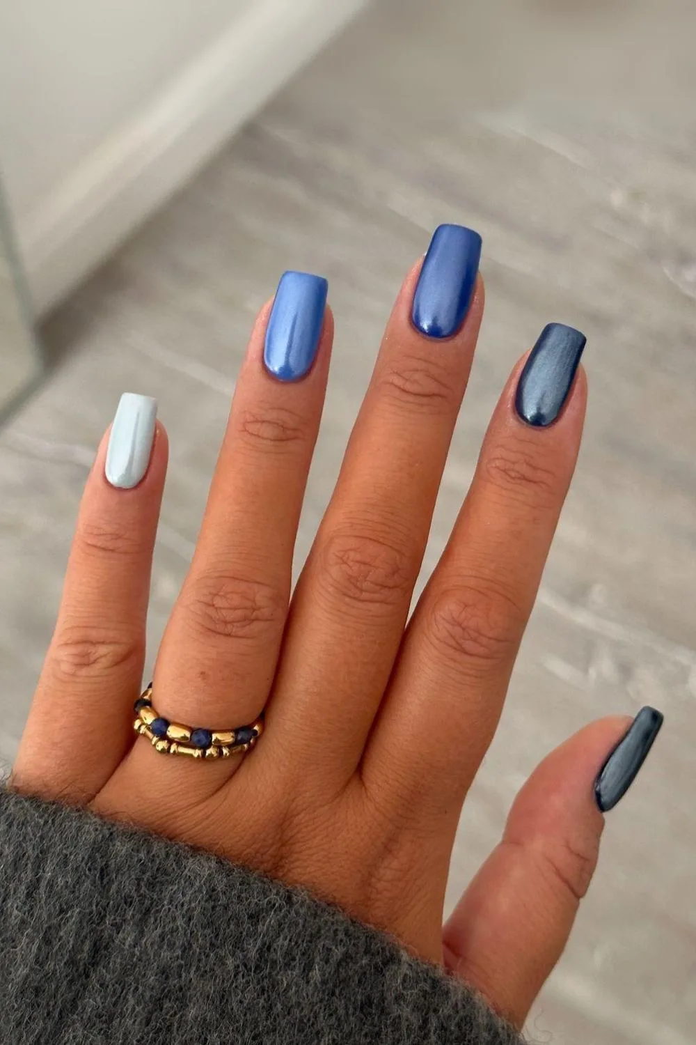 Dark-to-light blue chrome skittle nails