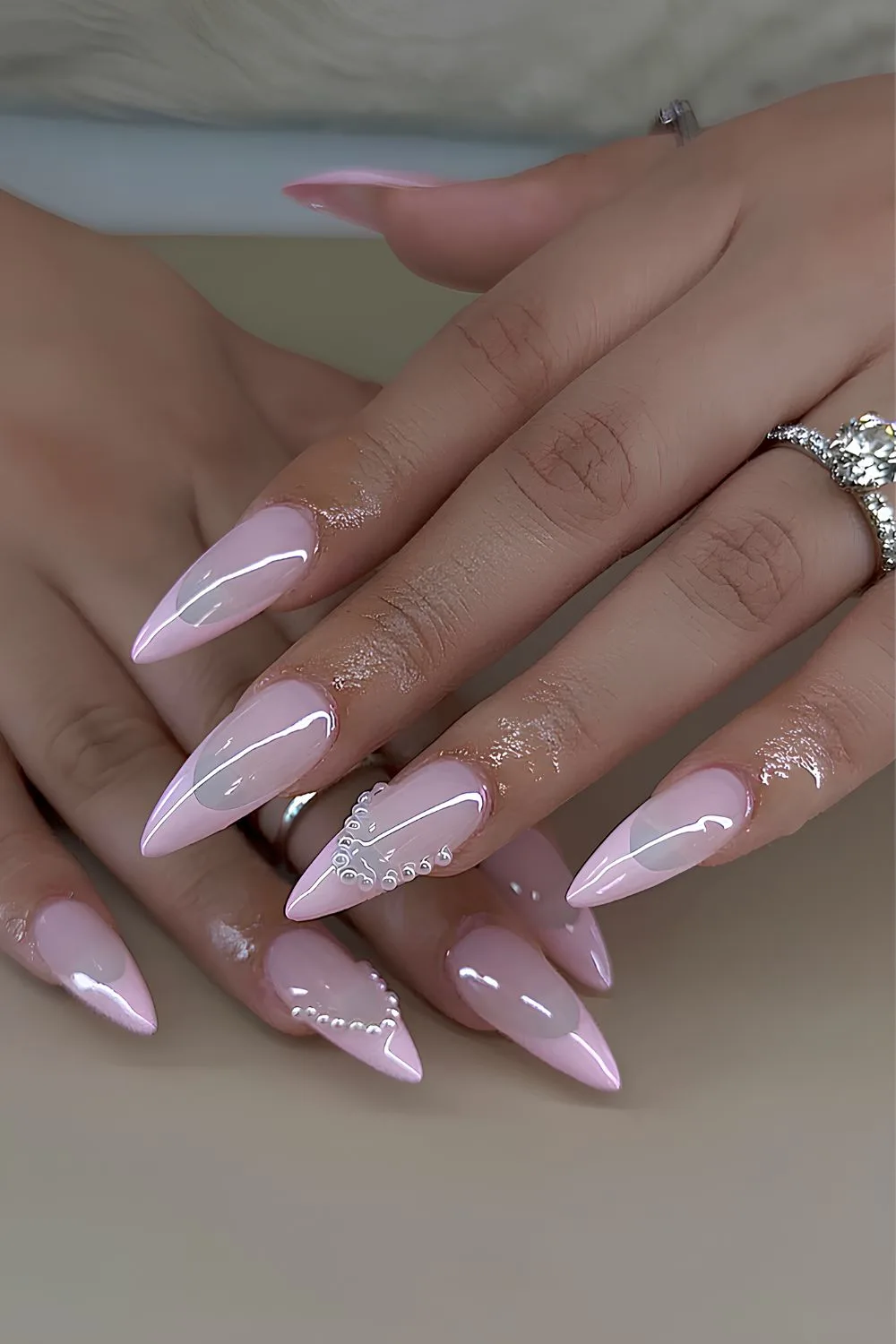 Light pink French nails with pearl accents