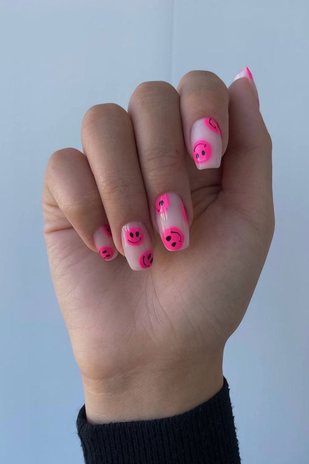 Neon pink smileys on clear nails