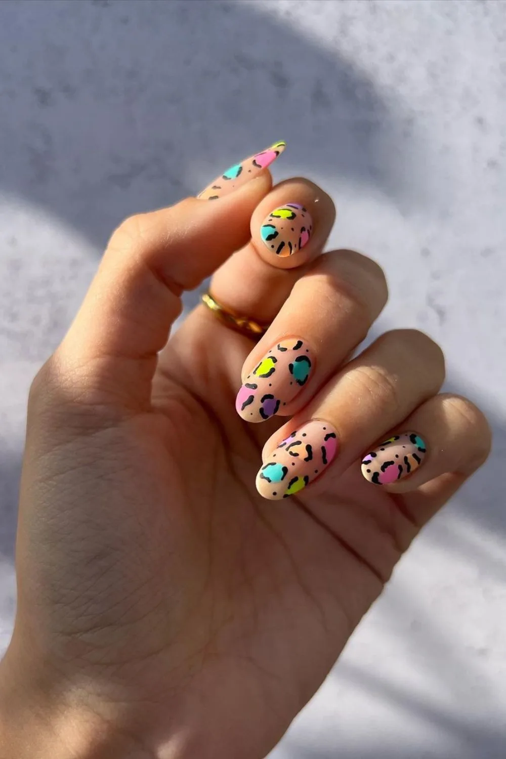 Nude nails with colorful leopard spots