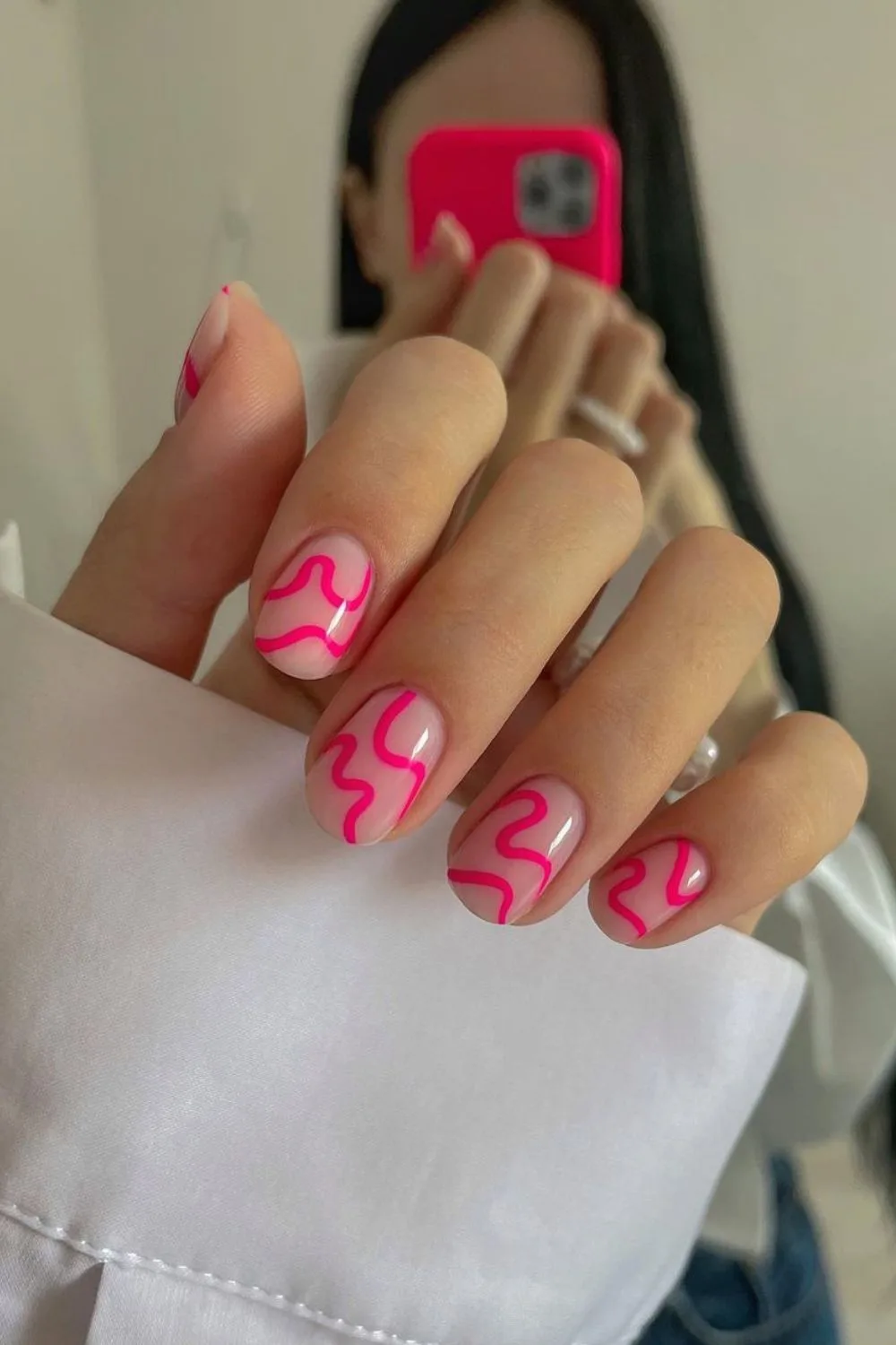 Nude nails with hot pink abstract lines