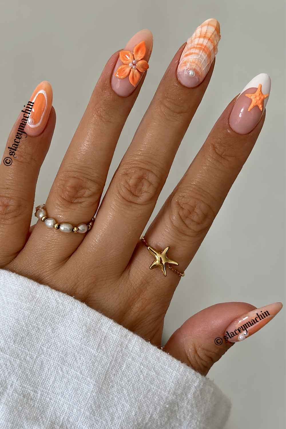 Orange summer nails with flowers and seashells