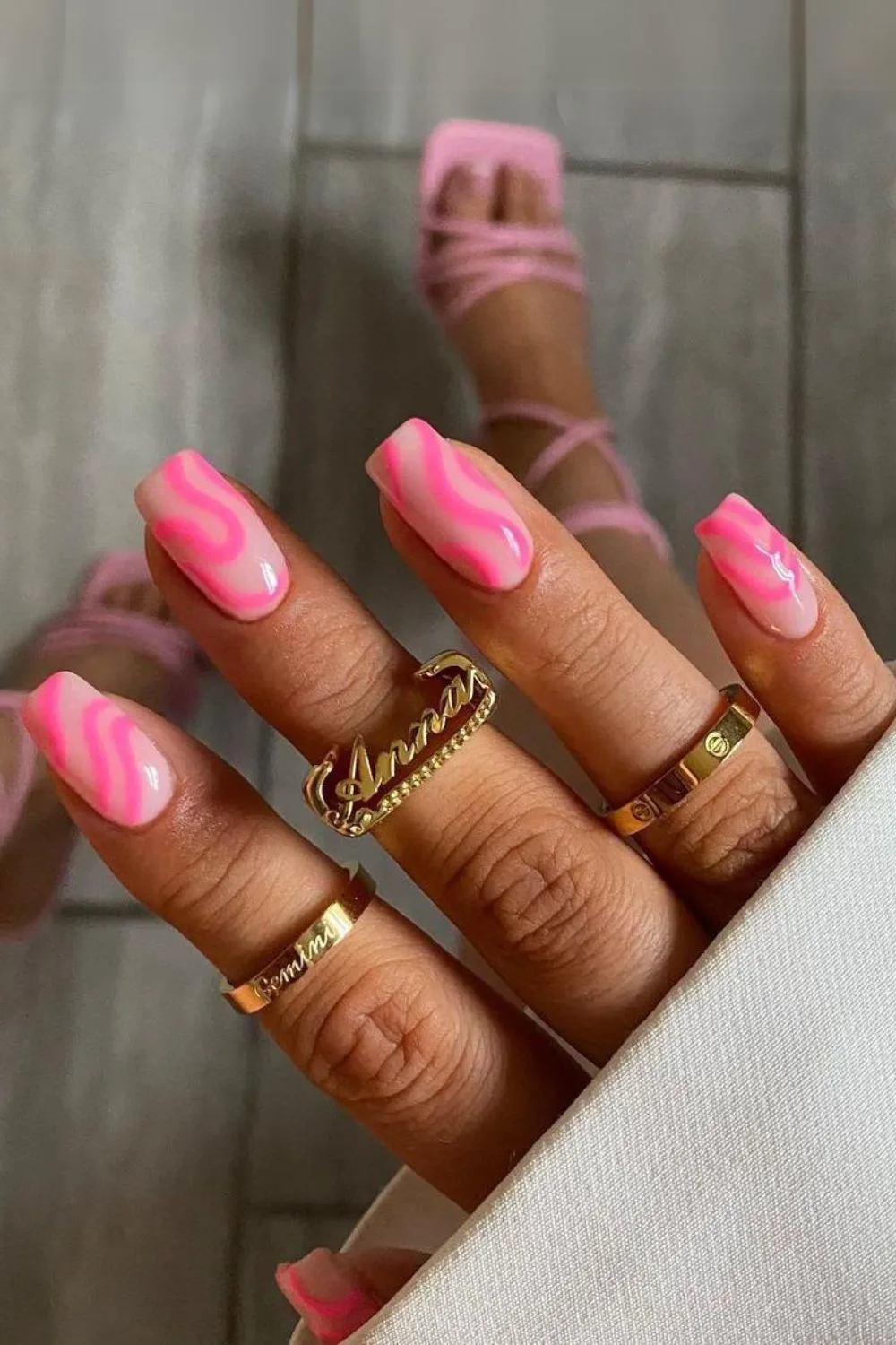 Pale pink nails with neon pink swirls