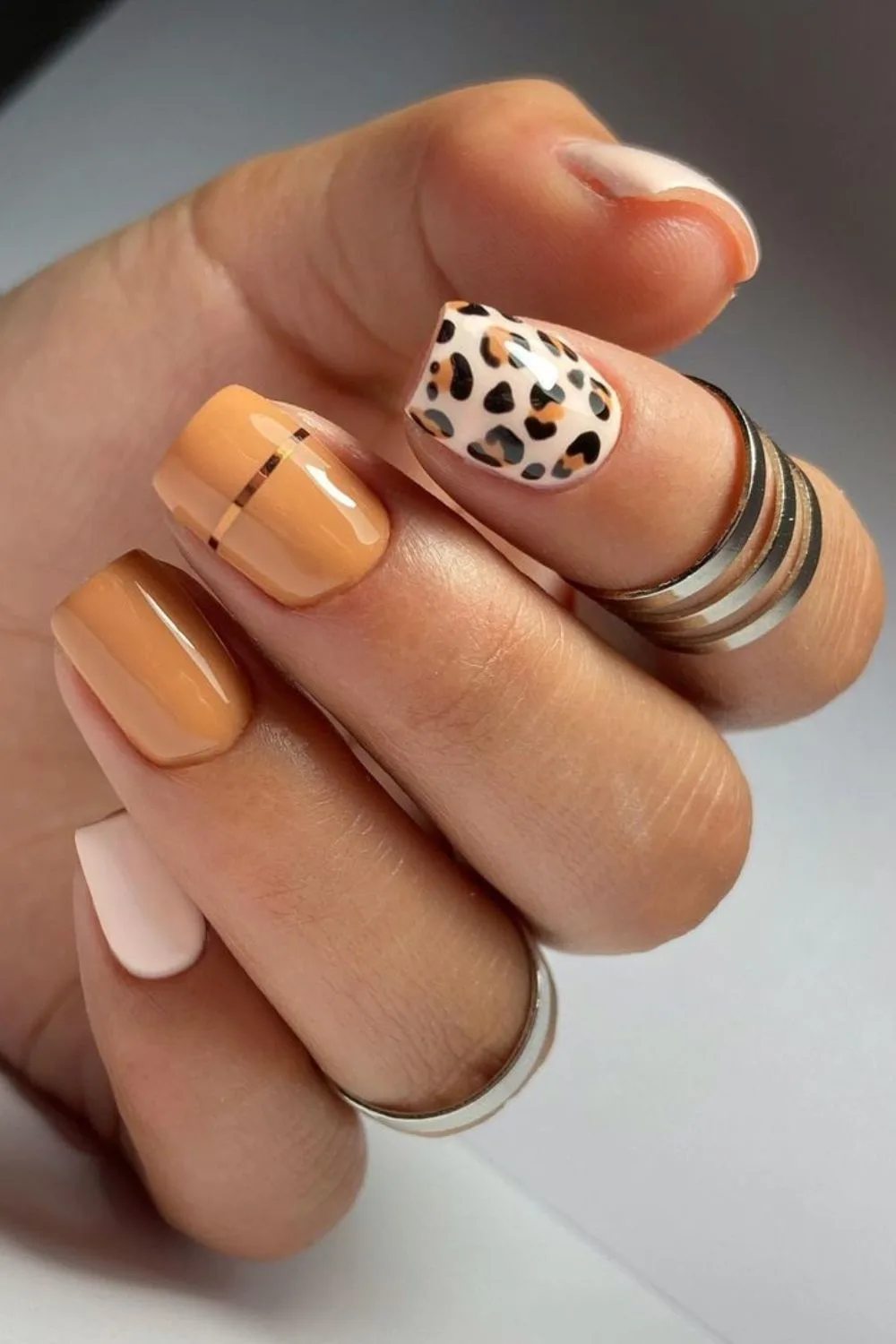 Peachy nude nails with leopard and gold details