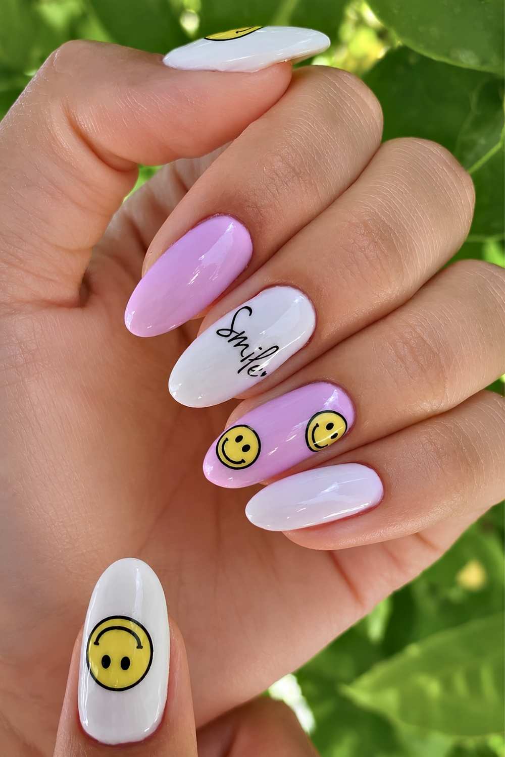 Pink and white nails wih happy faces and smile lettering