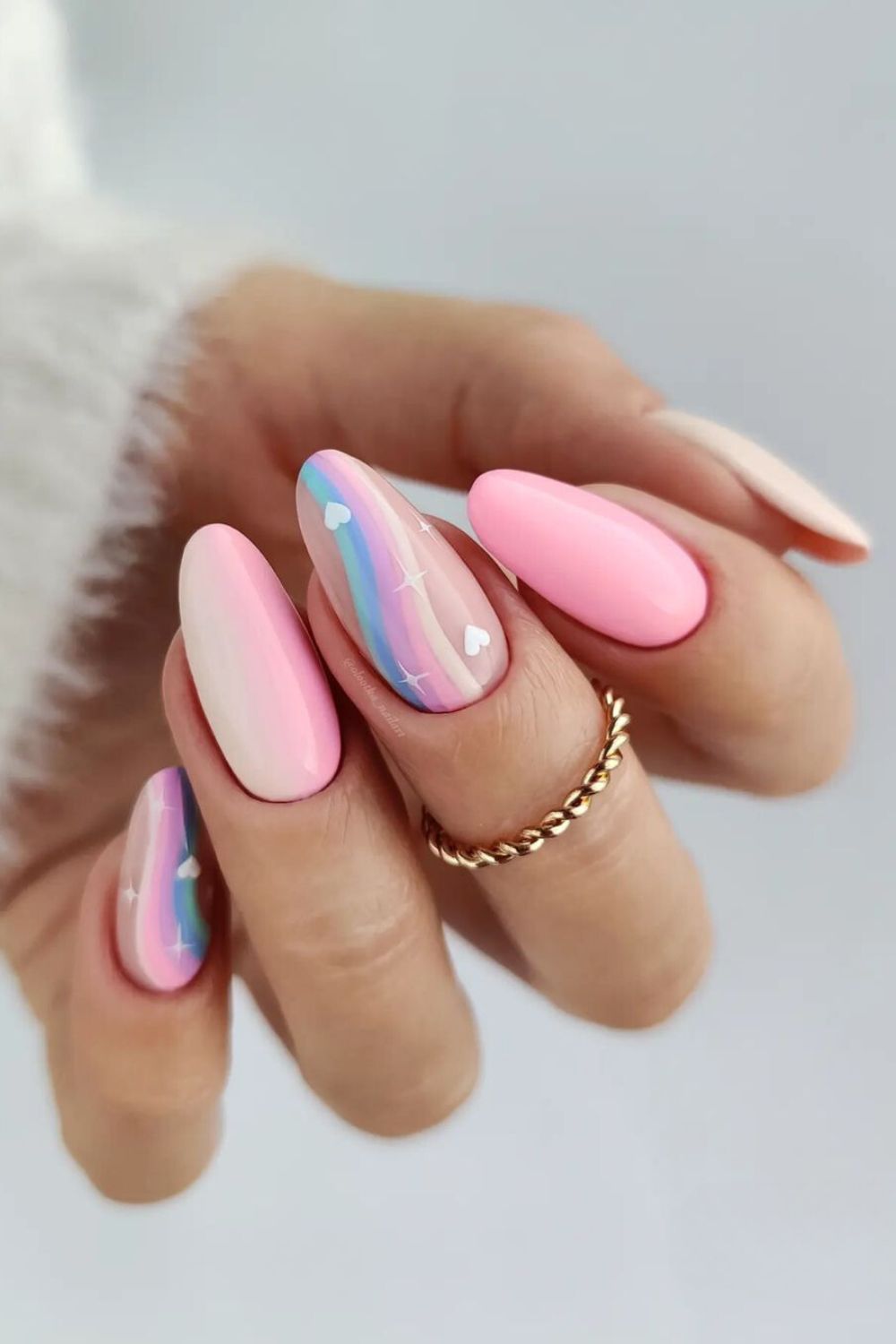 Pink nails with rainbow streaks and hearts