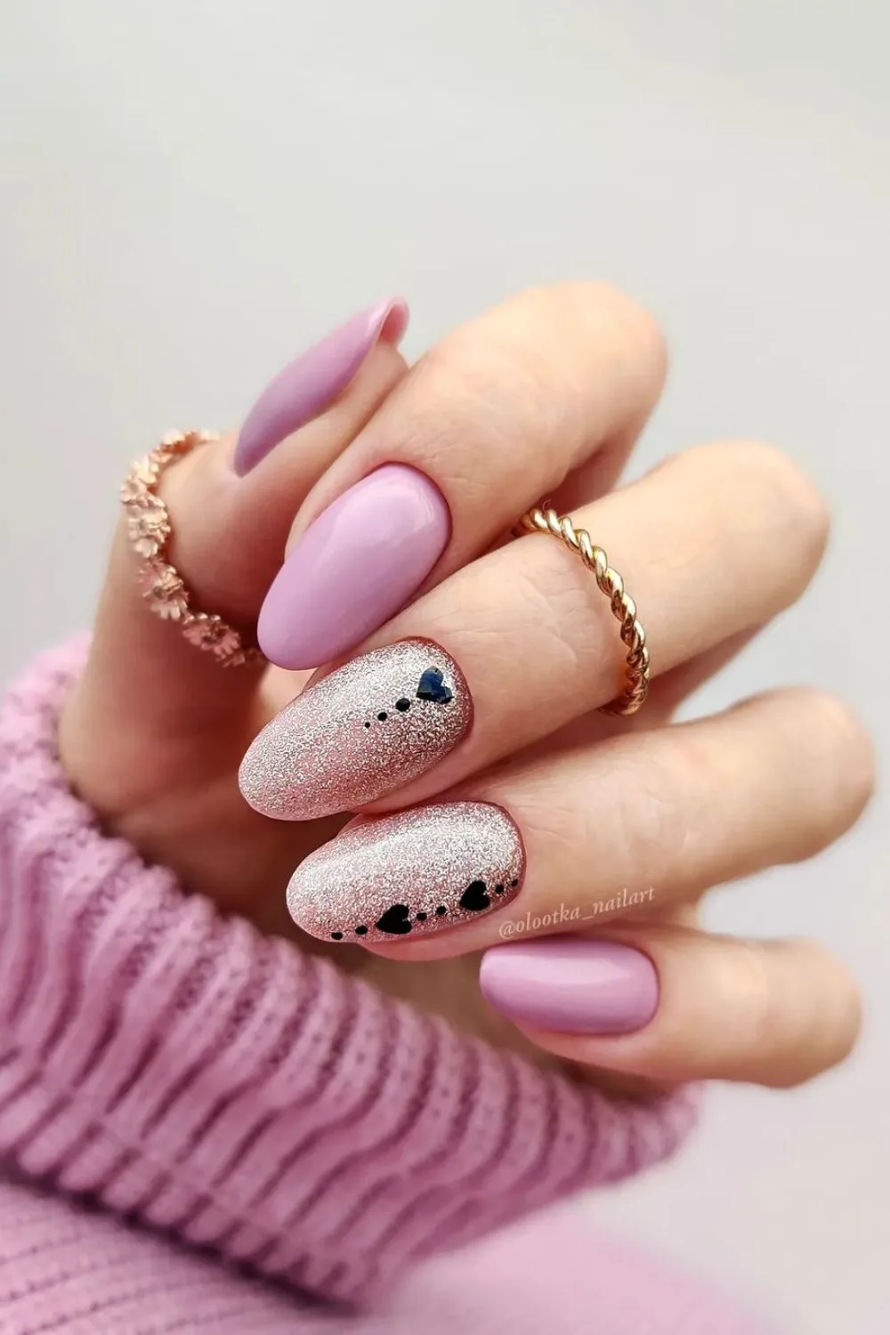 Pink nails with tiny black hearts