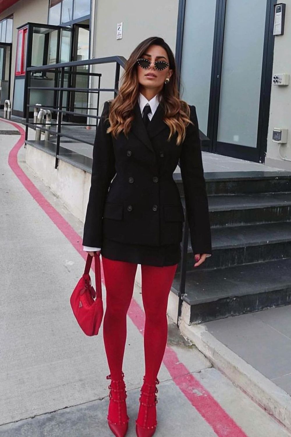 Red tights, red heels, and  black suit and tie