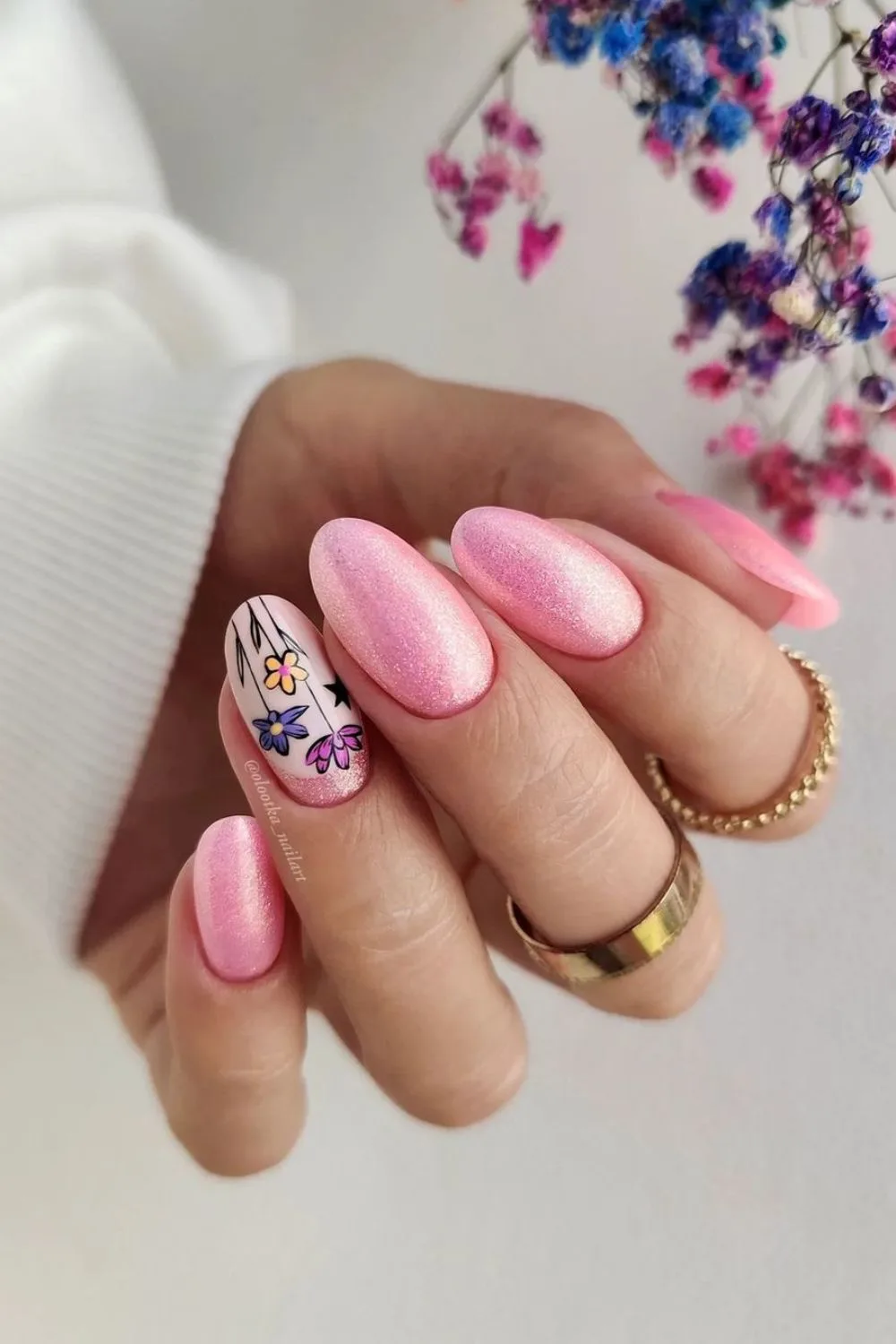 Shimmery pink nails with floral accents