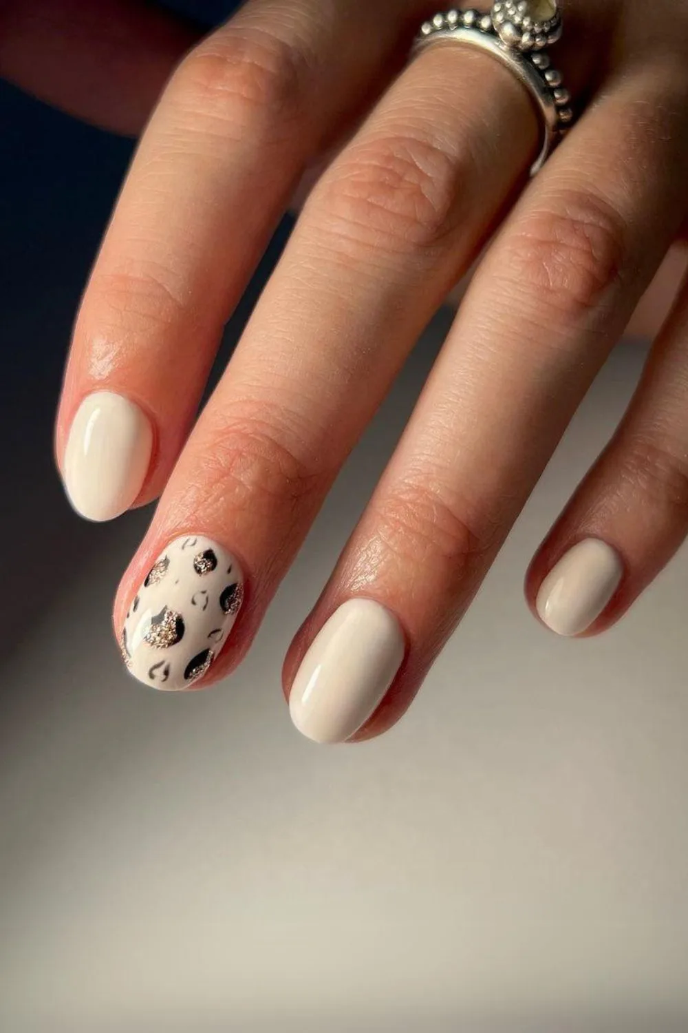 White nails with leopard accent finger