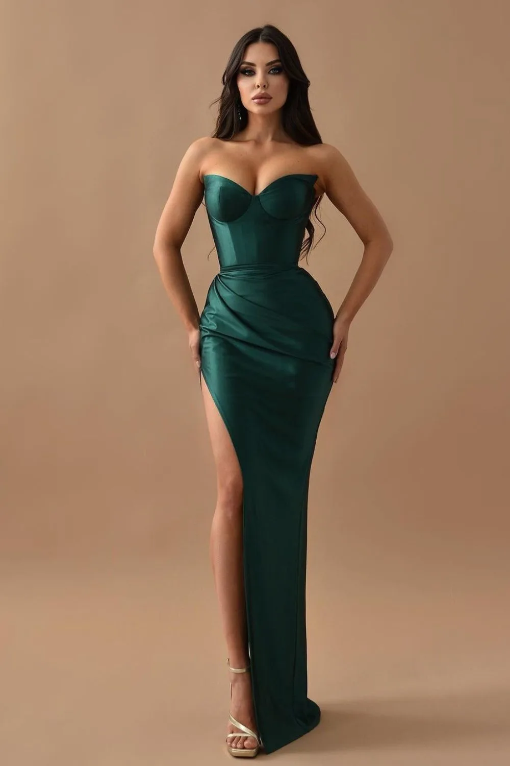 attractive woman in green dress posing