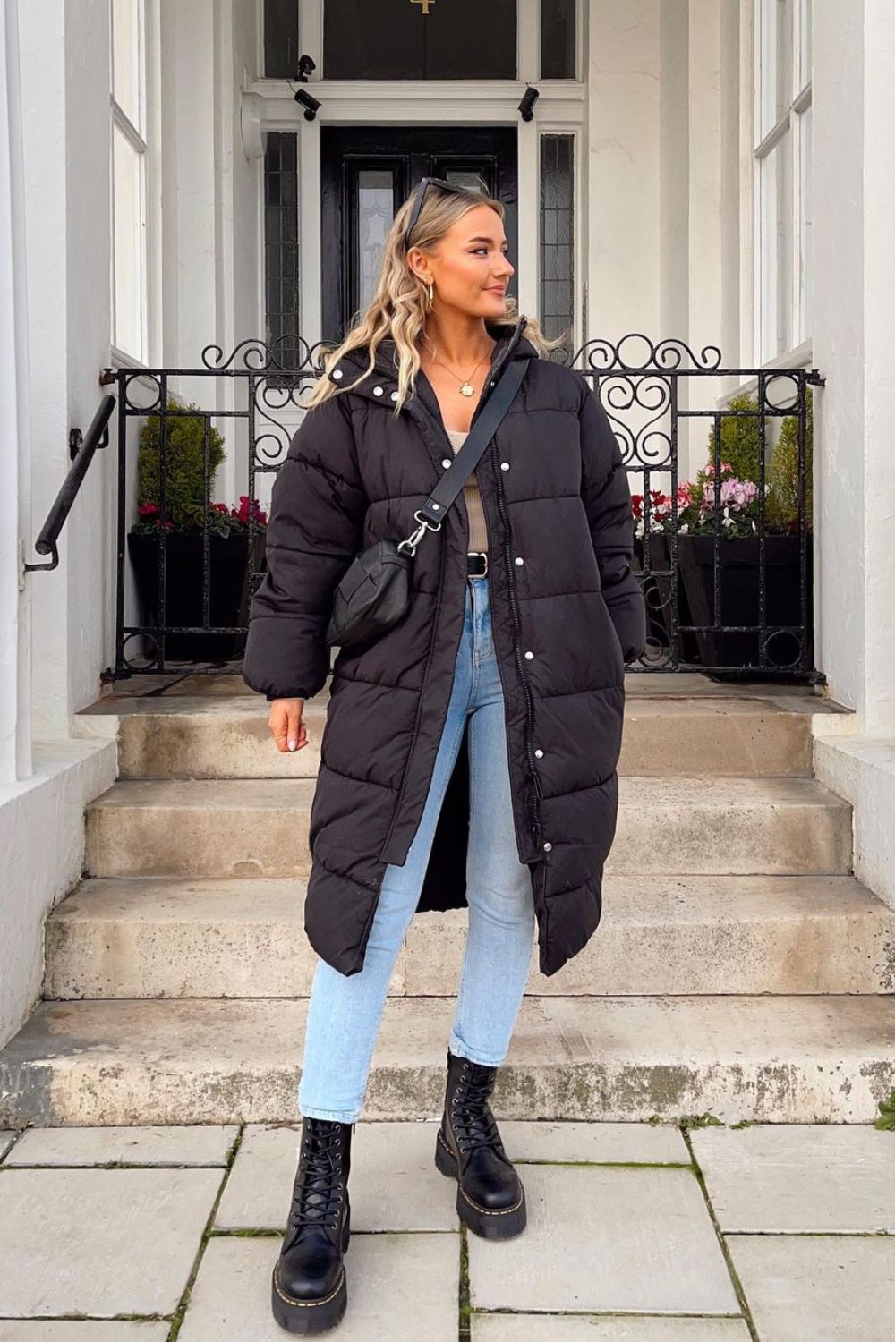 woman in black long jacket and denim