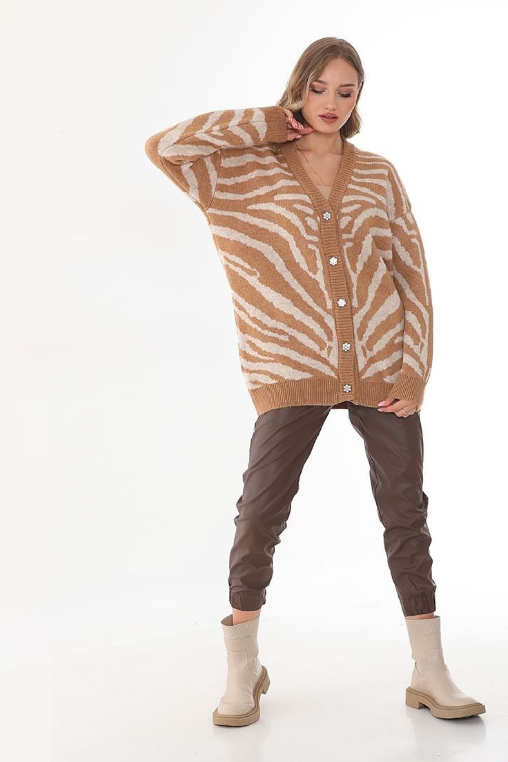 Woman in brown pants and zebra cardigan