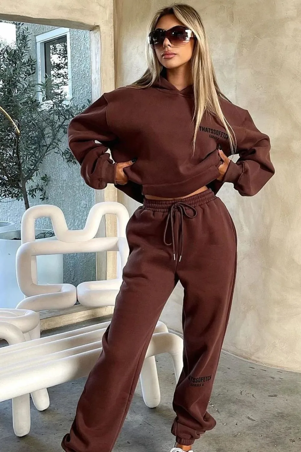 blond woman in brown tracksuit
