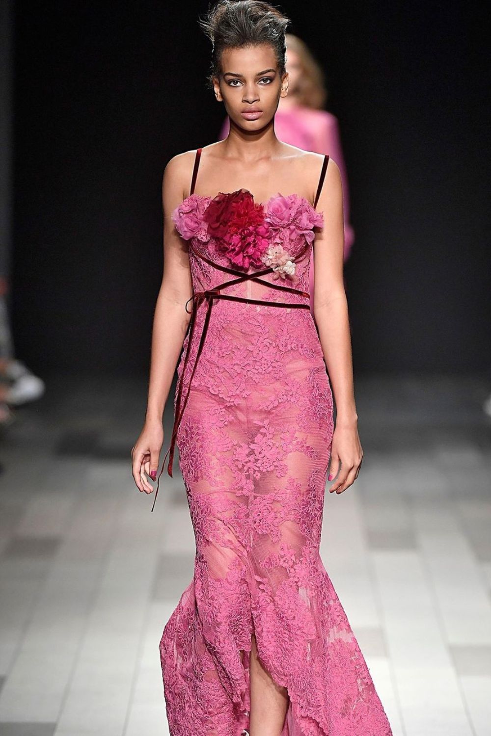 model walking in pink lace dress