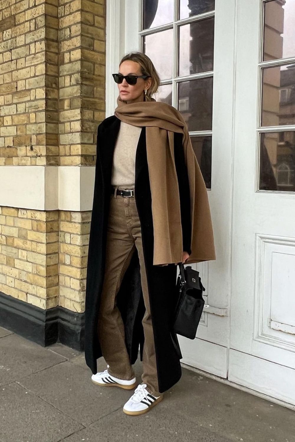 tailored trousers and black  coat with scarf