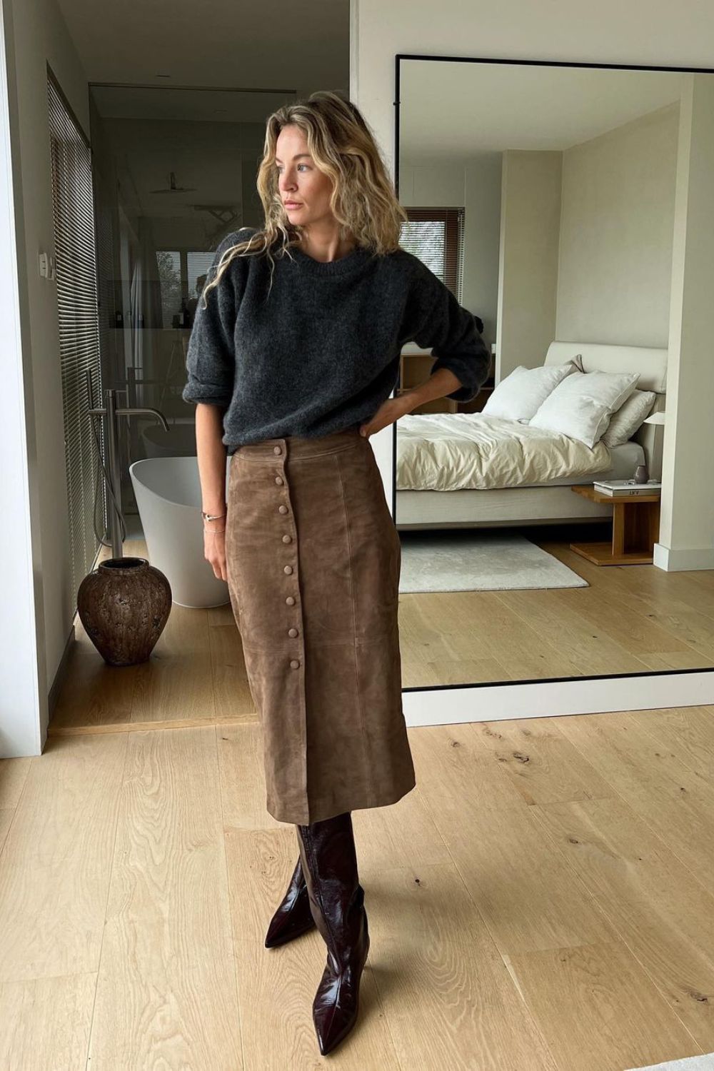 black jumper and brown skirt