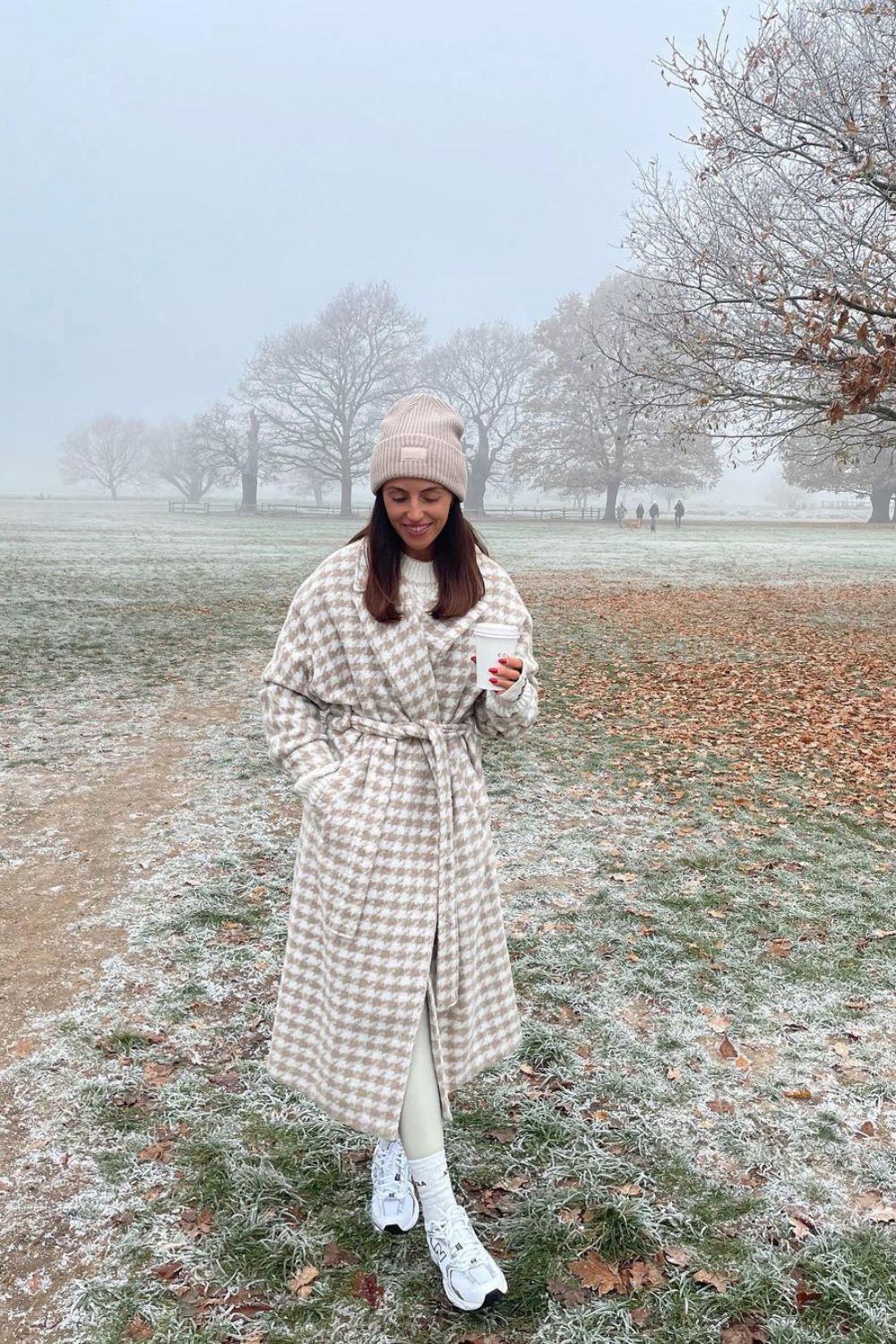 woman in white gray coat outdoors