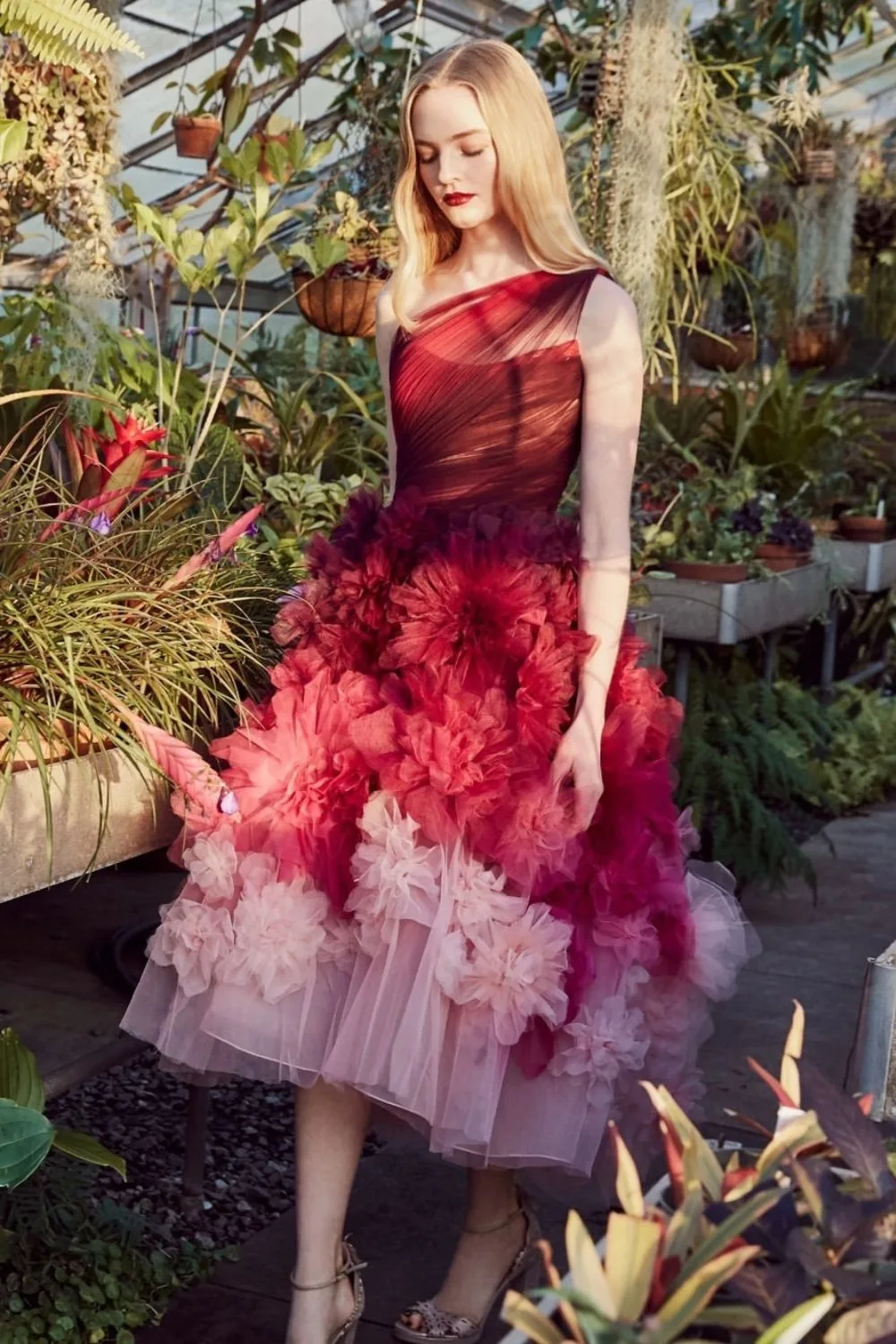 woman in red prom dress in a garden