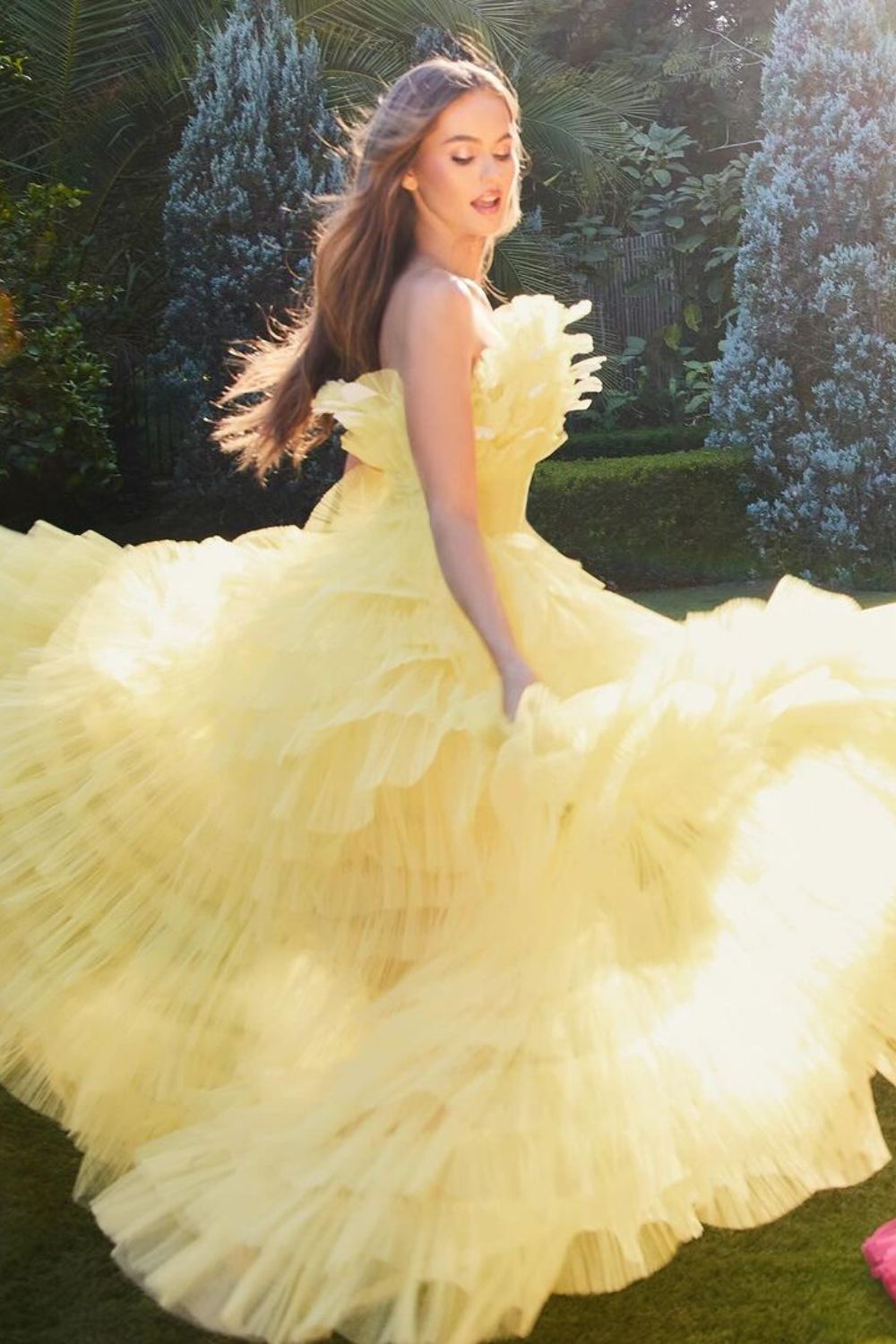 woman posing in yellow dress with frills