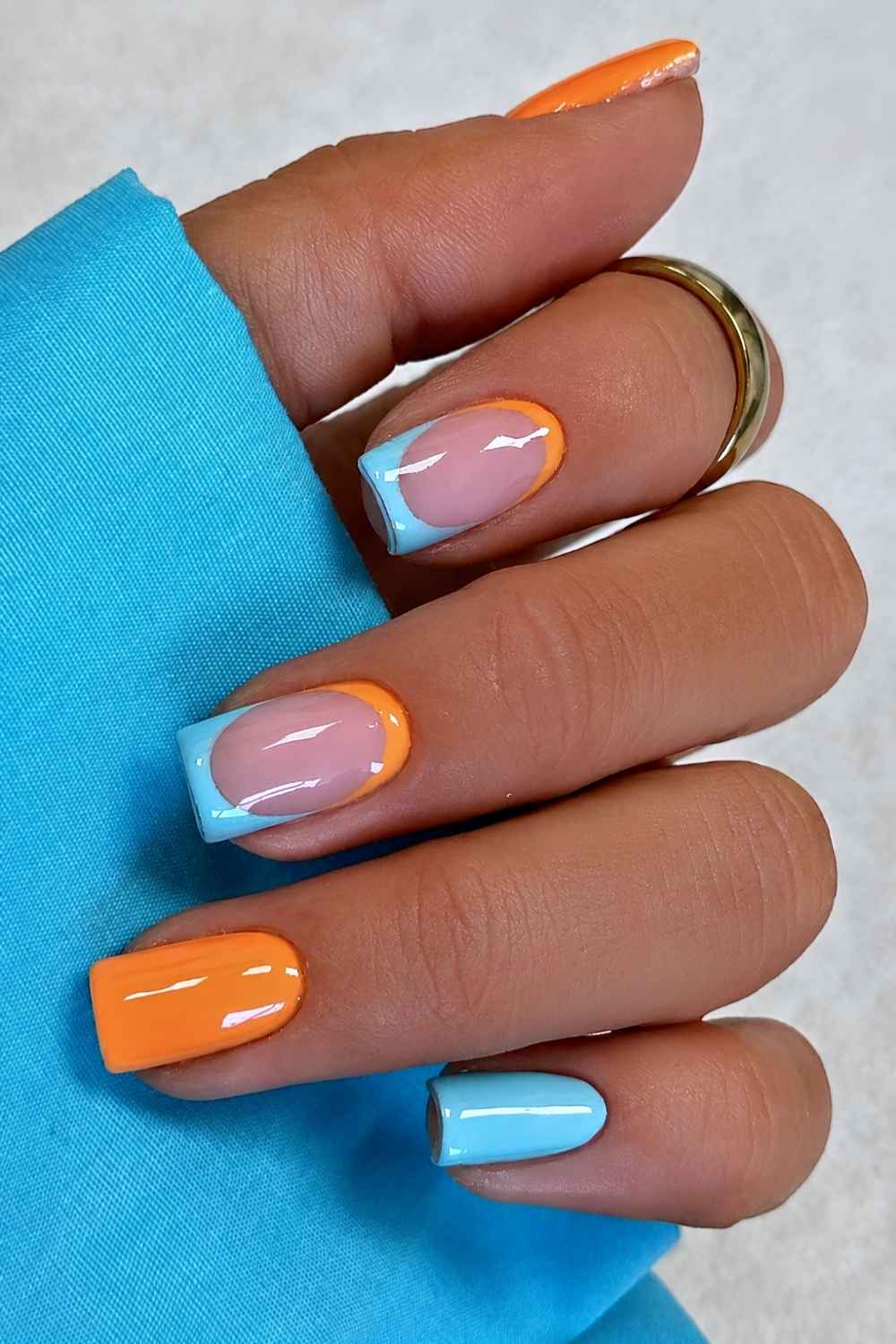 Blue and orange nails with negative space design