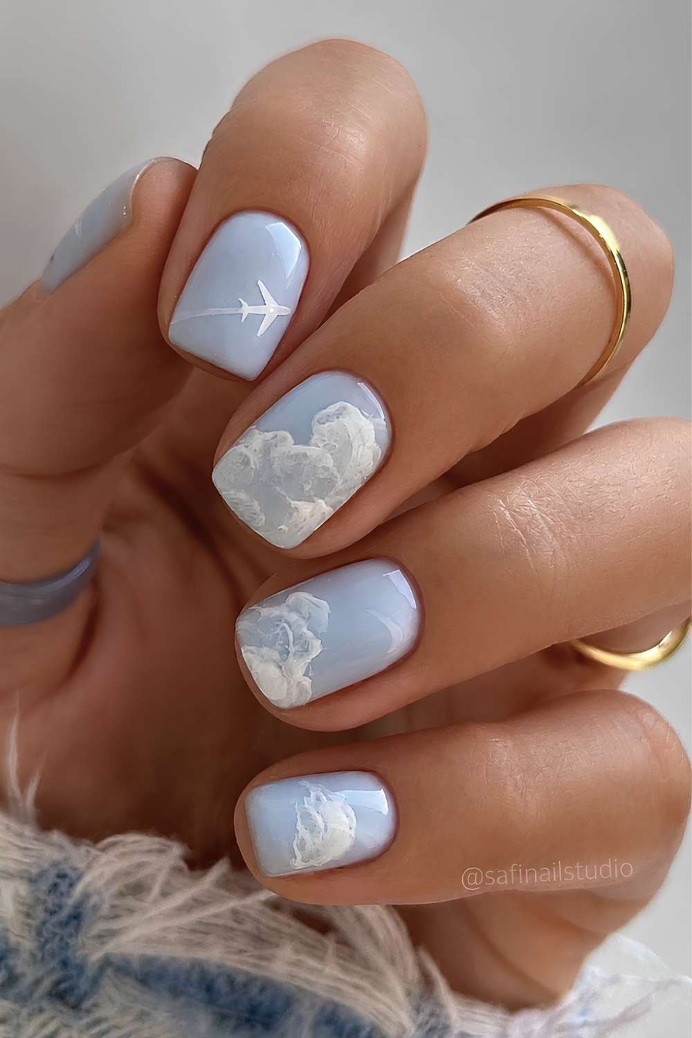 Blue mani with cloud and airplane art