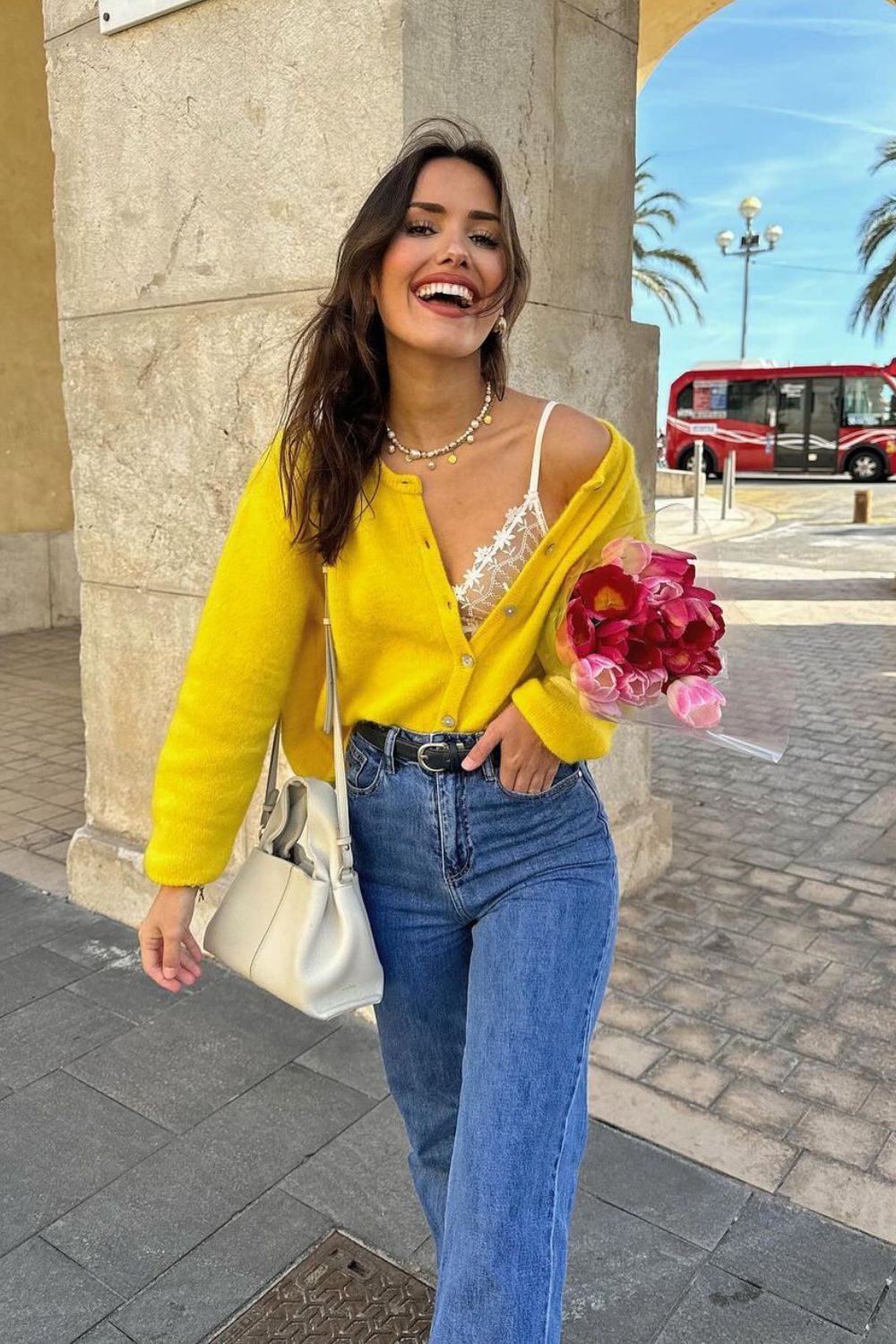 Bright yellow cardigan and blue jeans