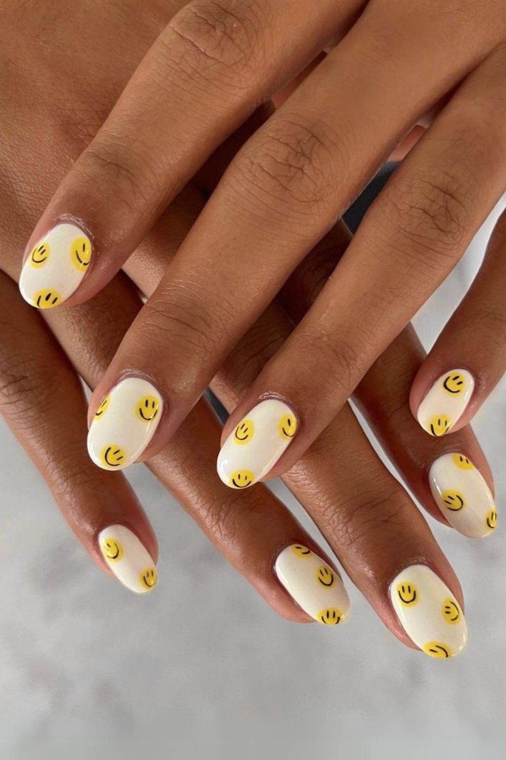 Butter yellow smiley face nails