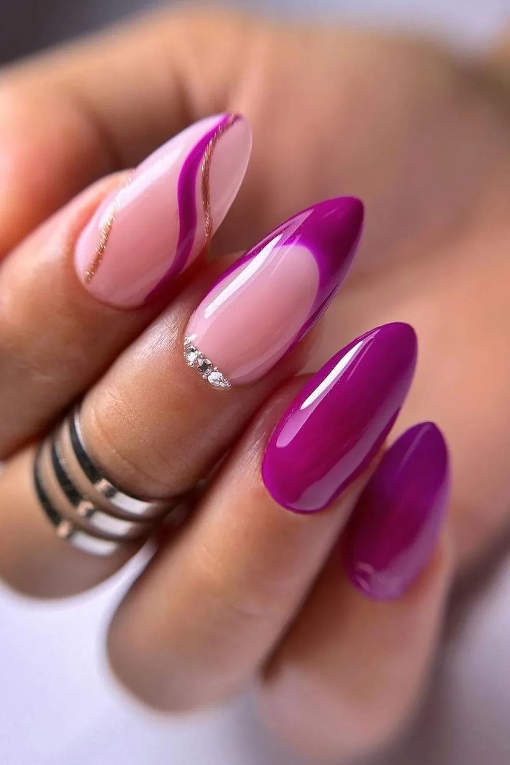 Deep pink nails with gold lines