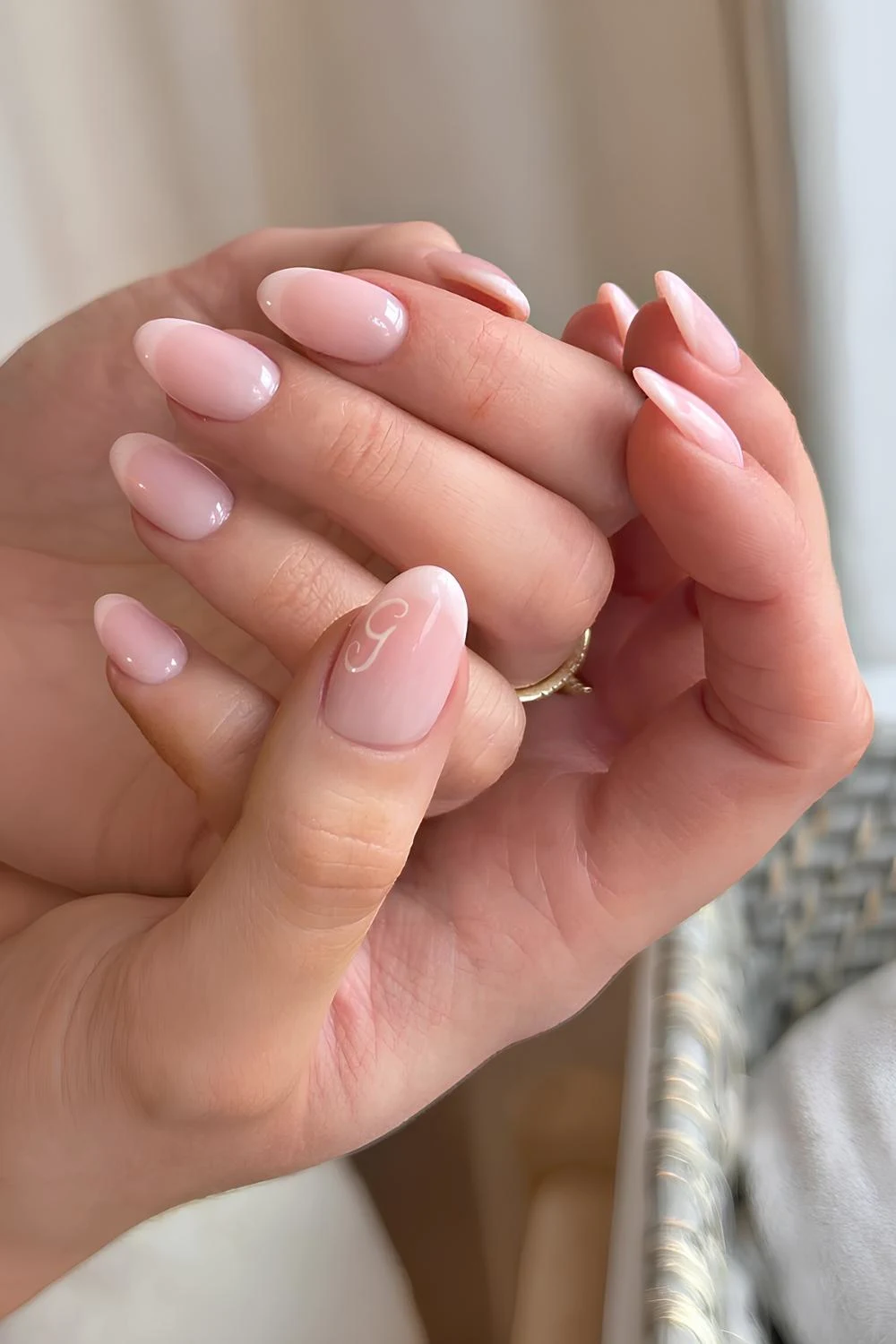 Faded white French manicure with a letter accent