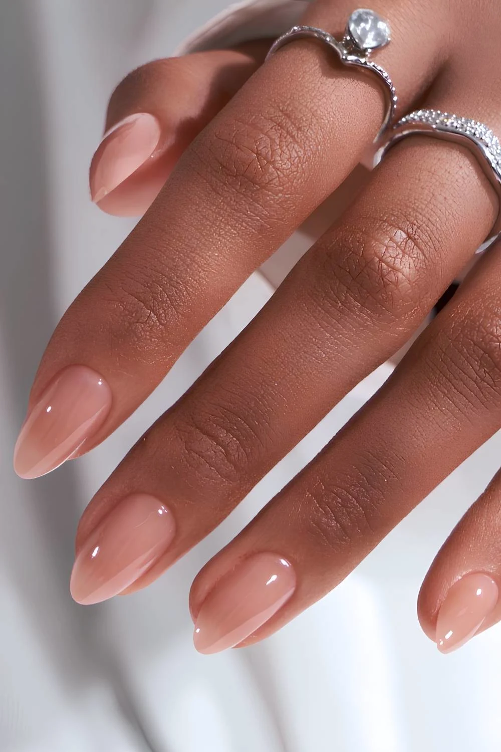 https://thepinkissue.com/wp-content/uploads/2024/06/Glossy-almond-nude-manicure.jpg.webp?utm_source=chatgpt.com