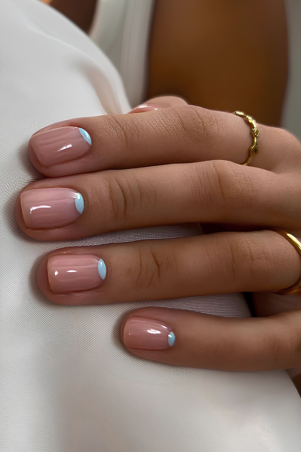 Glossy nails with light blue half-moon accents