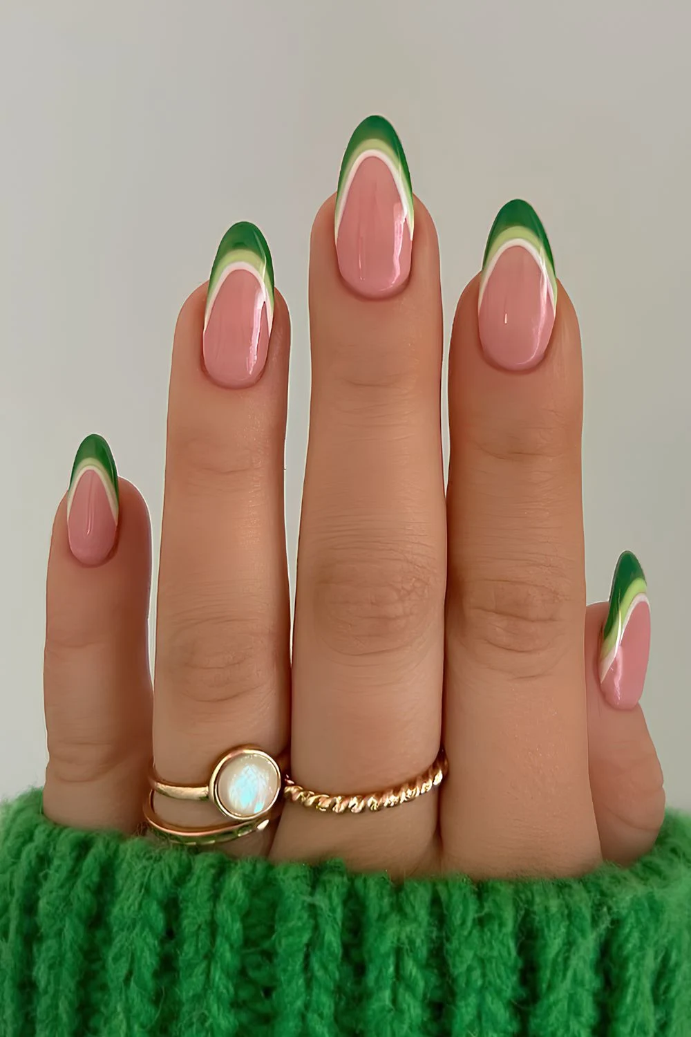 Green French manicure on a pink base