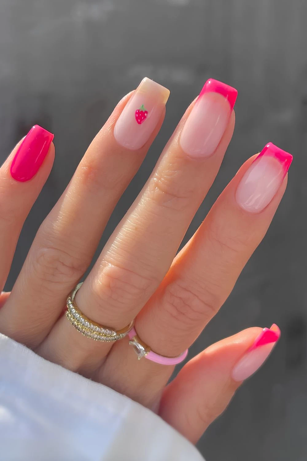 Hot pink nails with tiny strawberry art