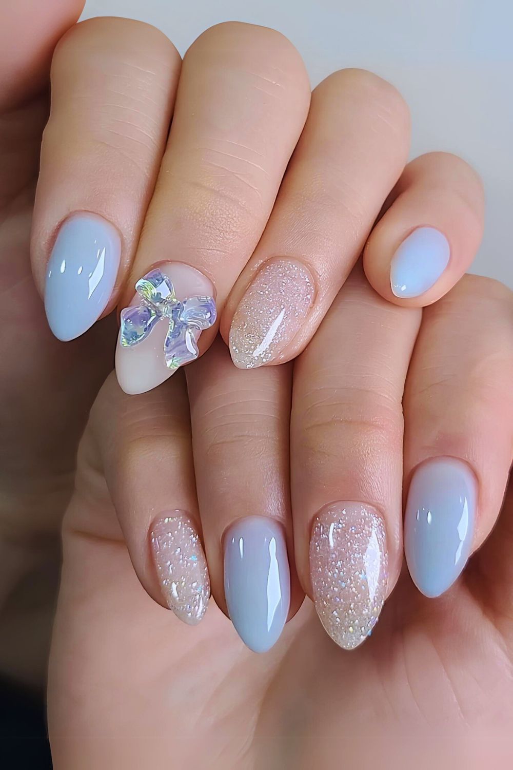 Light blue mani with bows and glitter