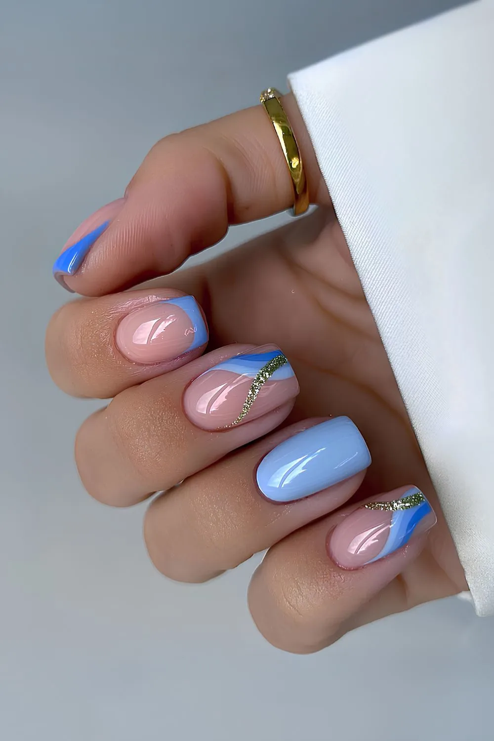 Light blue mani with glitter and swirl details