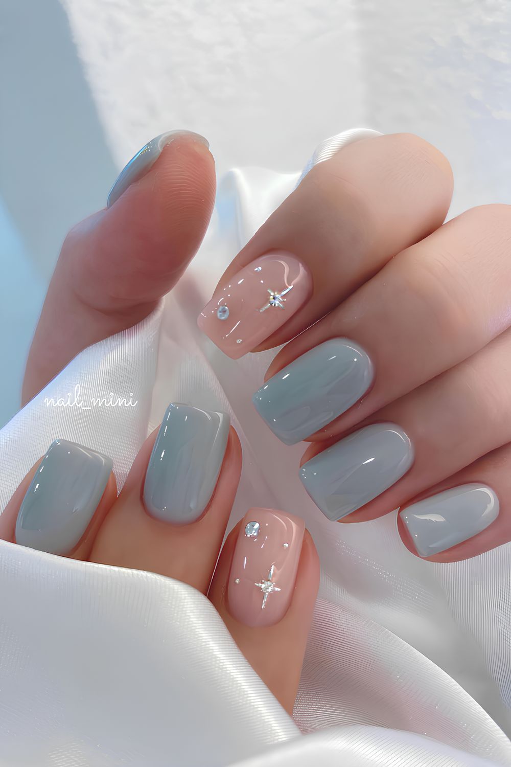 Light blue nails with accent gems