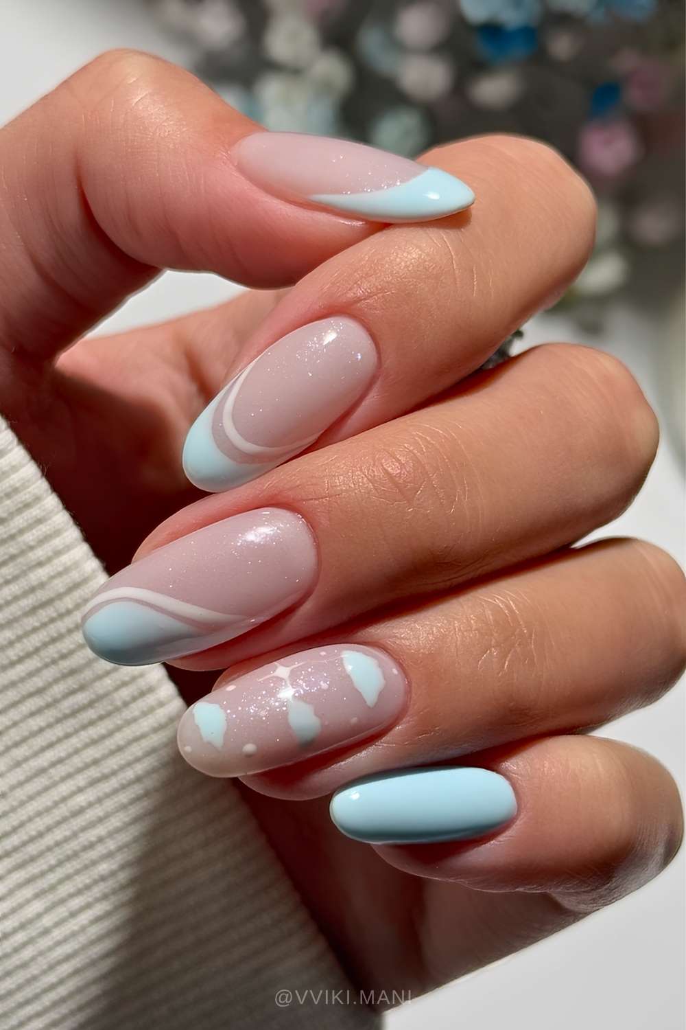 Light blue nails with clouds and line art