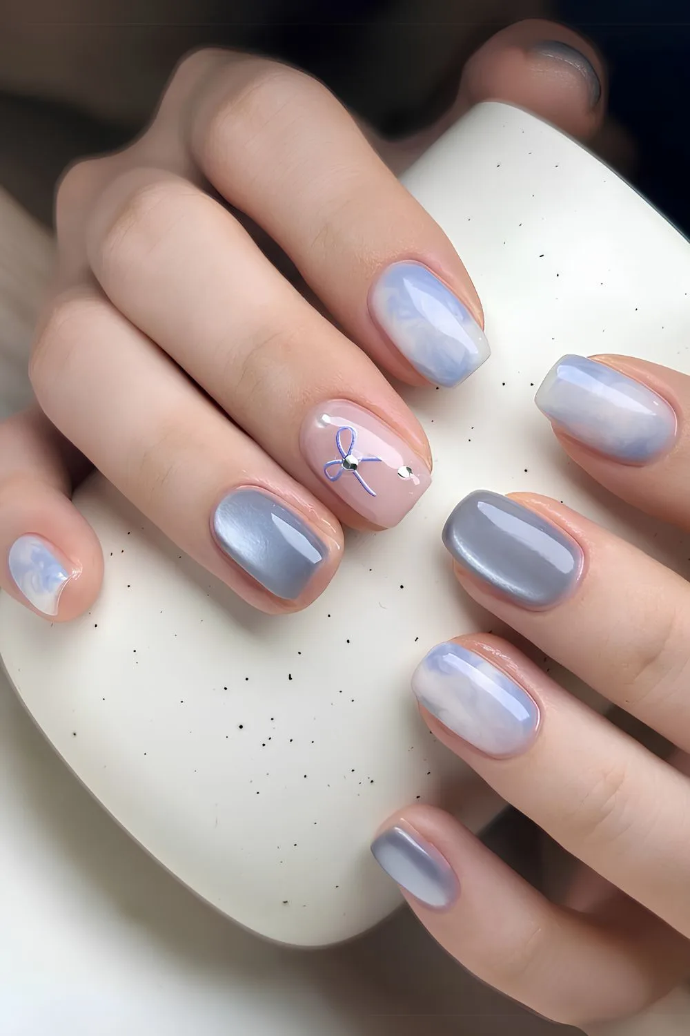 Light blue nails with marble and glass effect