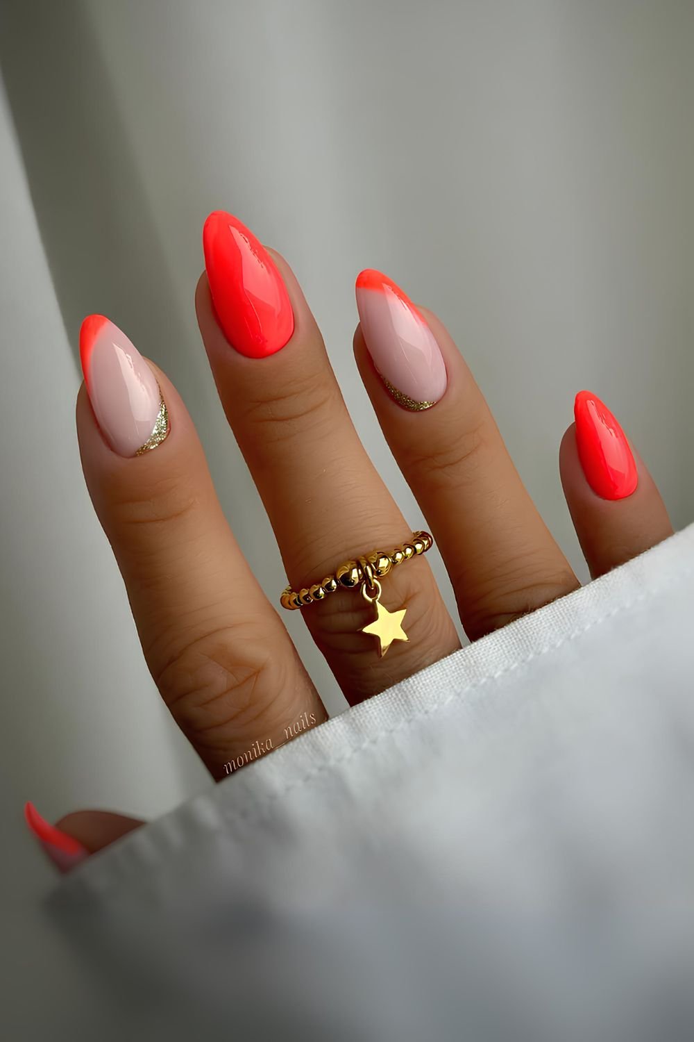 Milky and neon orange mani with gold slitter accent