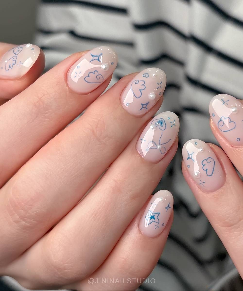 Milky white nails with blue doodle clouds