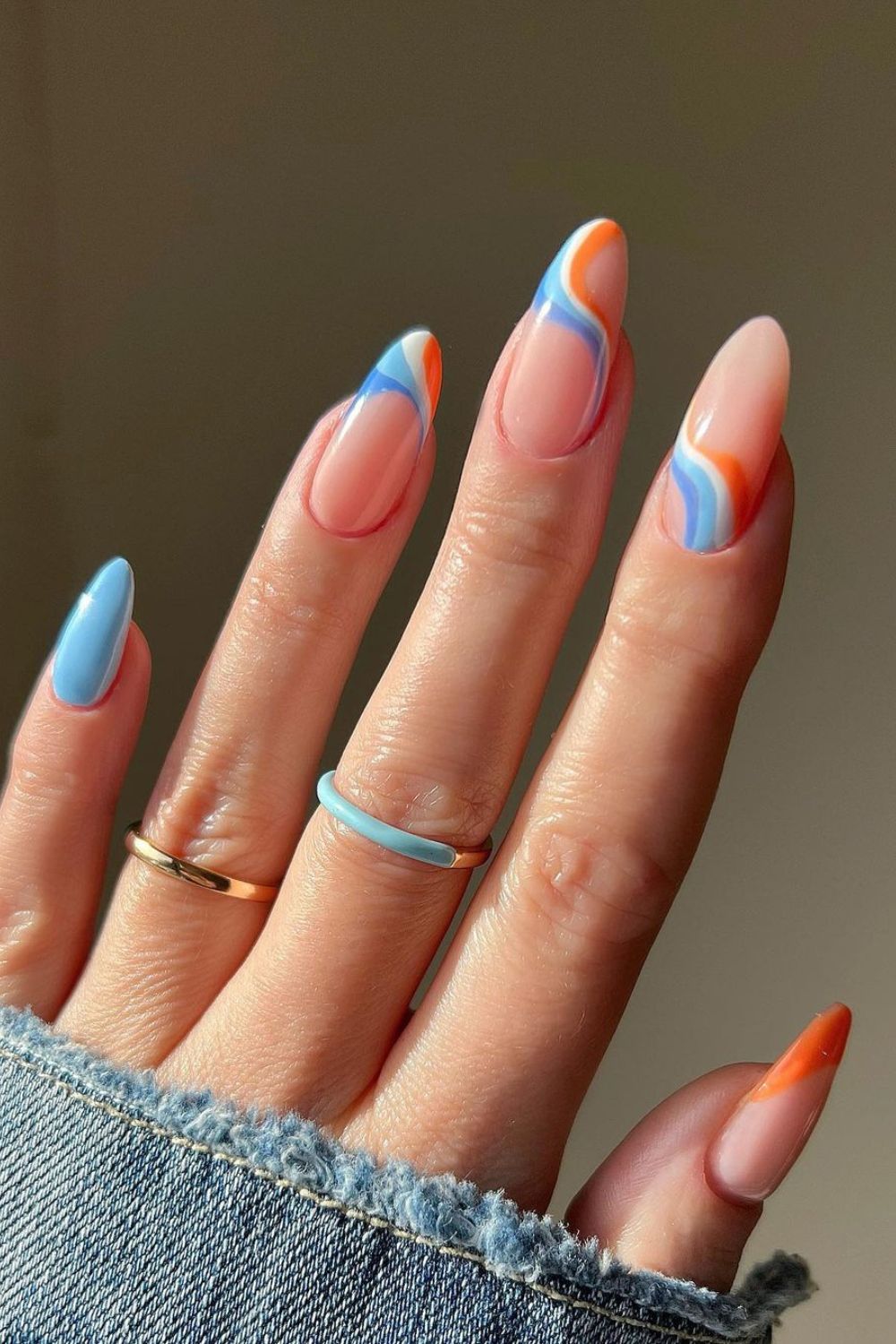 Nails with blue and orange swirls