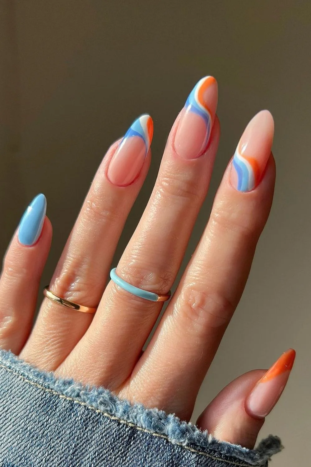 Nails with blue and orange swirls