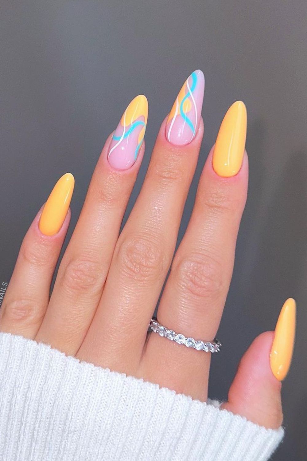 Nails with yellow and blue swirls