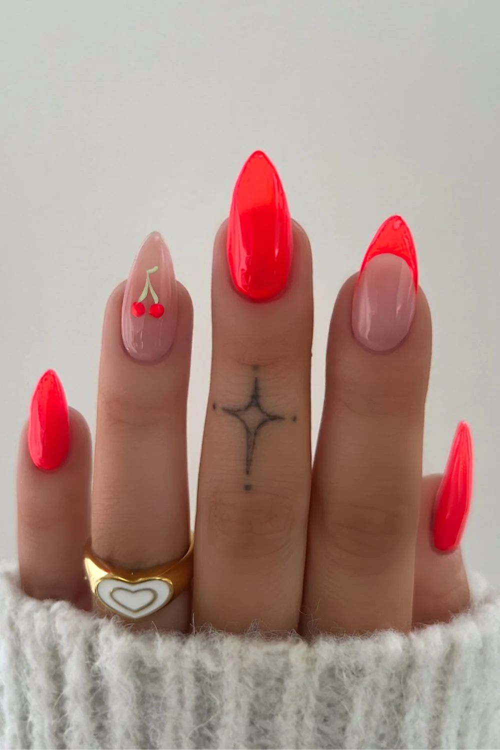 Neon coral mani with cherry accent