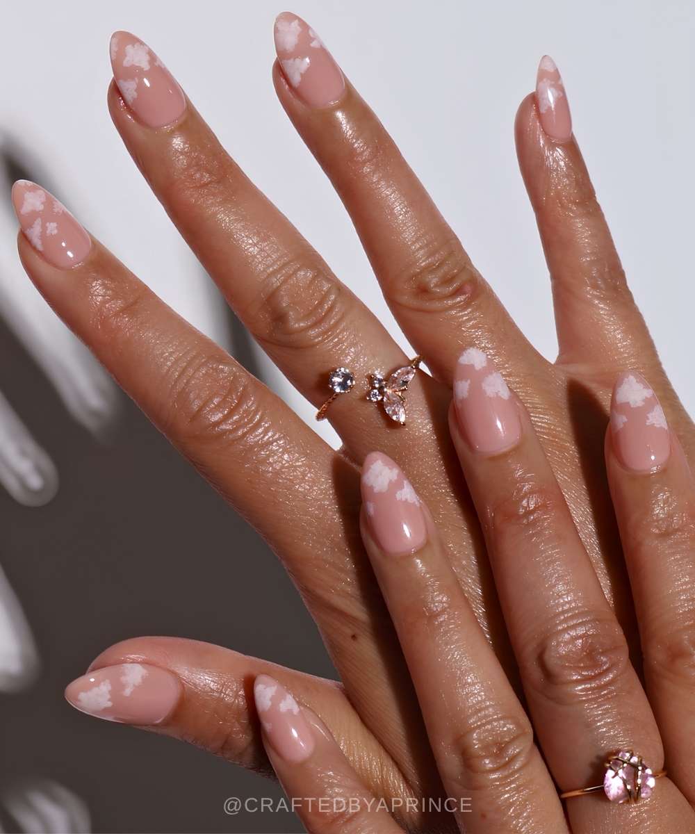 Neutral pink nails with delicate cloud art